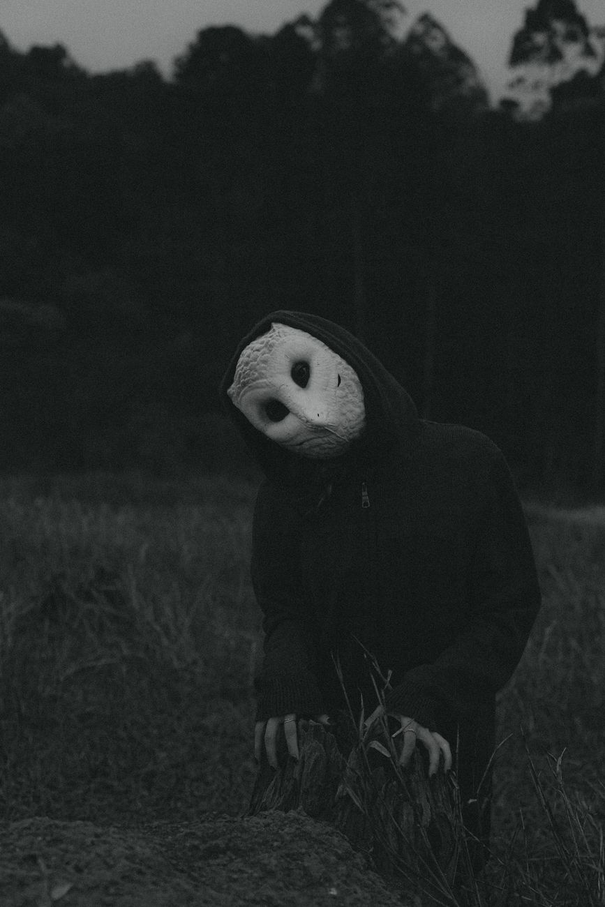 person wearing a scary halloween owl mask